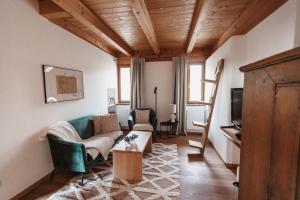 a living room with a couch and a chair at Ferienhaus Am Grassnitzberg 18 in Straß in Steiermark