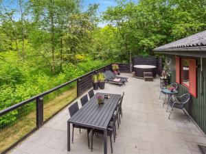 a patio with a table and chairs on a balcony at Holiday Home Nyalle - 30km from the sea by Interhome in Toftlund