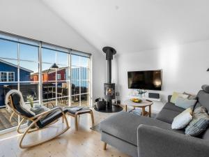 a living room with a couch and a large window at Holiday Home Albertina - 300m to the fjord by Interhome in Hvide Sande