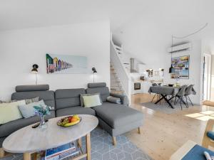a living room with a couch and a table at Holiday Home Albertina - 300m to the fjord by Interhome in Hvide Sande +10 photos