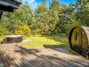 a circular building on a deck next to a yard at Holiday Home Eli - 1-5km to the fjord by Interhome in Blåvand +17 photos