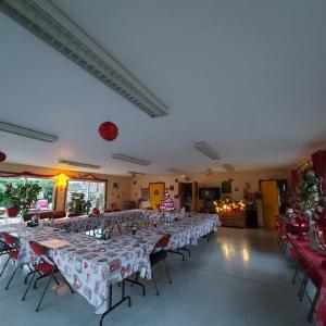 a large room with many tables and chairs in it at Le Chti Paradis in Méricourt