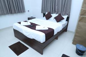 a bedroom with a bed with white sheets and pillows at Hide away stay in Pune