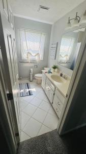 a bathroom with a sink and a toilet and a mirror at Kid Friendly, 12 min to ND in Granger +11 photos