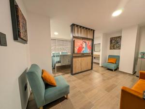 a living room with a couch a chair and a television at Lienzo Suite in Popayan +9 photos