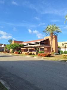 ein Gebäude mit einer Palme vor einer Straße in der Unterkunft Valle Alegre in El Valle del Espíritu Santo