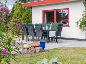 un patio avec une table et des chaises dans une cour dans l'établissement Holiday Home Hakon - 550m from the sea by Interhome, à Gedser