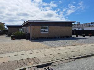 a brick house with a driveway in front of it at Holiday Home Falk - 900m from the sea by Interhome in Skagen +32 photos