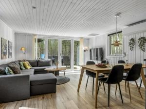 a living room with a couch and a table at Holiday Home Tellervo - 1-5km from the sea by Interhome in Læsø