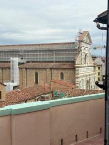 a view from the roof of a building with a clock tower at Bohèmian View Santa Maria Novella in Florence