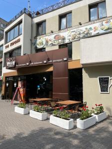 a restaurant with tables and chairs in front of a building at Міні-готель Три Корони in Lviv
