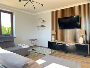a living room with a couch and a flat screen tv at Rendez-vous in Kielce