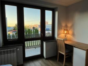 a room with a desk and windows with a view at Rendez-vous in Kielce