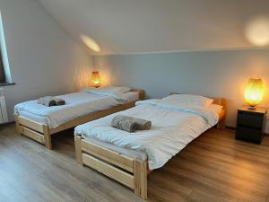 two twin beds in a room with two lamps at Rendez-vous in Kielce