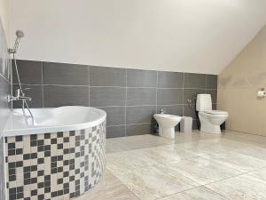 a bathroom with a bath tub and a toilet at Rendez-vous in Kielce +14 photos
