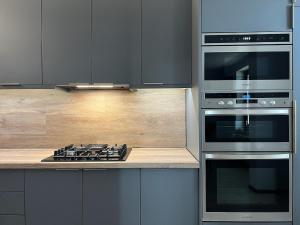 a kitchen with stainless steel appliances and a stove at Rendez-vous in Kielce