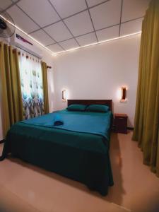 a bedroom with a large bed in a room at Yesumishi Airport Villas - Transit Hotel Katunayake in Seeduwa