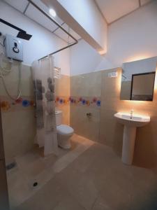 a bathroom with a toilet and a shower and a sink at Yesumishi Airport Villas - Transit Hotel Katunayake in Seeduwa