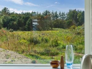 a window with a view of a field of grass at Holiday Home Yakari - 1km from the sea by Interhome in Torsted
