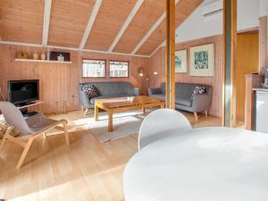 a living room with a couch and a table at Holiday Home Anttoni - 50km from the sea by Interhome in Ansager