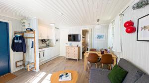 a living room with a couch and a table at Dragsö Camping & Stugby in Karlskrona