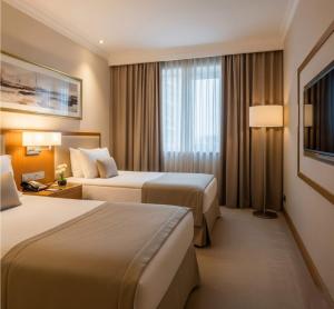 Postel nebo postele na pokoji v ubytování Xetai Royal Hotel & Restaurant