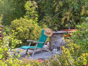 a hat sitting on a chair next to a table at Holiday Home Aslak - 600m from the sea by Interhome in Glesborg