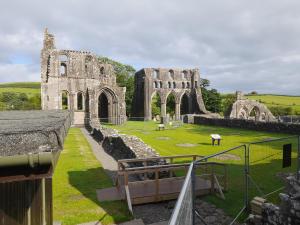 an old castle with a church in the distance at Kirkcudbright Holiday Apartments - Apartment B in Kirkcudbright