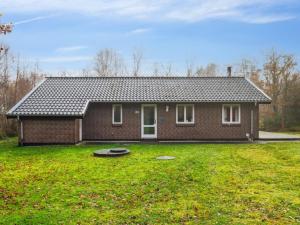 a brick house with a large yard in front of it at Holiday Home Patrik - 200m to the fjord by Interhome in Fur