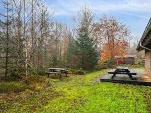 a picnic table and benches in a park at Holiday Home Patrik - 200m to the fjord by Interhome in Fur