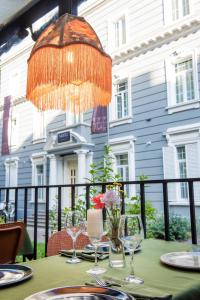 a table with wine glasses and a chandelier at Hotel Twenties Tbilisi - Stay & Dine in Tbilisi City +87 photos