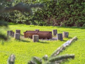 a metal object sitting in the middle of a field at Holiday Home Berta - 70m to the fjord by Interhome in Roslev