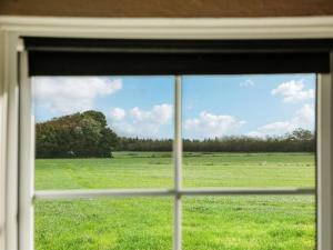 a view of a field from a window at Holiday Home Haralde by Interhome in Bredebro