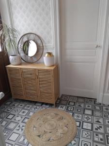 a room with a door with a mirror and a rug at L'appart in Vinneuf