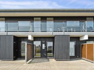an external view of a building with glass doors at Apartment Kimi - 100m from the sea by Interhome in Havneby
