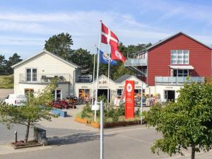 a flag flying in front of a red building at Apartment Kimi - 100m from the sea by Interhome in Havneby