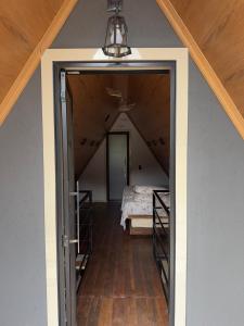 an open doorway to a room with a bed at Chalé Vale da Paz 500m da Praca in Palmeiras