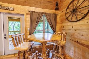 a dining room with a wooden table and chairs at A Little River Romance - Private Dock - Hot Tub in Mentone +12 photos