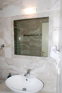 a bathroom with a sink and a mirror at Ippotamos House in Agios Nikolaos