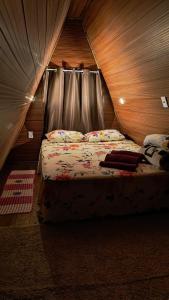 a bedroom with a bed with a canopy at Chalé Estrela Cadente in Palhoça