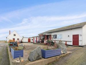 a building with a sign in front of it at Holiday Home Elvira - 300m from the sea by Interhome in Svaneke