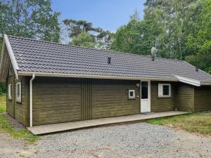 a small house with a garage at Holiday Home Ellynor - 600m from the sea by Interhome in Neksø