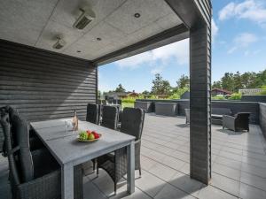 an outdoor patio with a table and chairs at Holiday Home Henrikke - 500m to the fjord by Interhome in Skjern