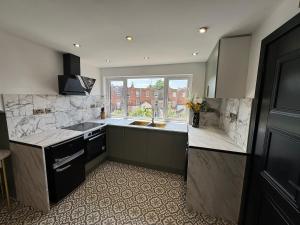 a large kitchen with a sink and a window at Green Gable Hideaway in Gloucestershire +7 photos