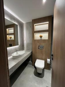 un bagno con un water bianco e un lavandino di 7th floor Studio a Xánthi