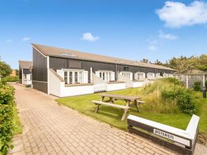 a picnic table and a bench in front of a building at Apartment Milly - 150m to the inlet by Interhome in Vestervig