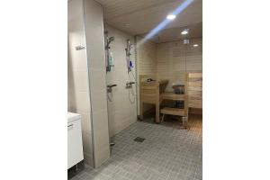 a bathroom with a shower and a table in it at Snowflake XI Family rooms in Rovaniemi