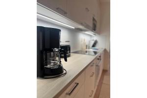 a kitchen with a coffee maker on a counter at Snowflake XI Family rooms in Rovaniemi