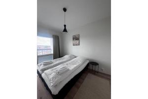 a bed in a room with a window at Snowflake XI Family rooms in Rovaniemi