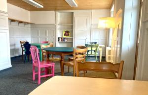 a dining room with colorful tables and chairs at Garni Sternen in Obstalden